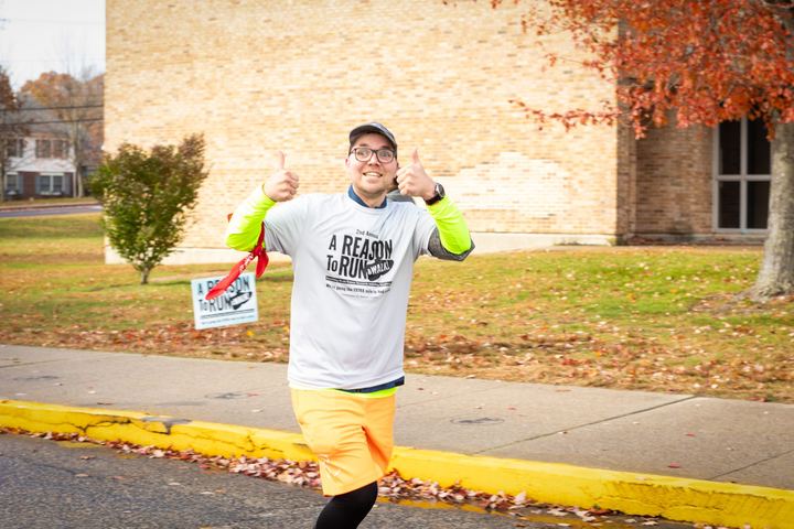 A participant giving a thumbs up while walking the course