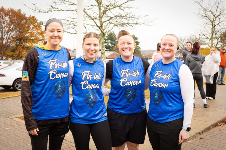 Four friends in matching blue event t-shirts